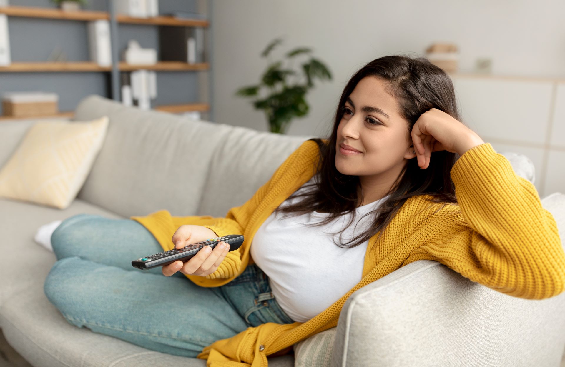 Woman-watching-tv-yellow-sweater
