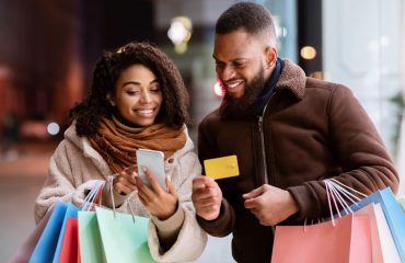 African American man and women shopping and using mobile