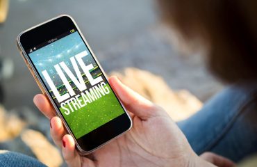 Person on Smartphone with text Live Streaming