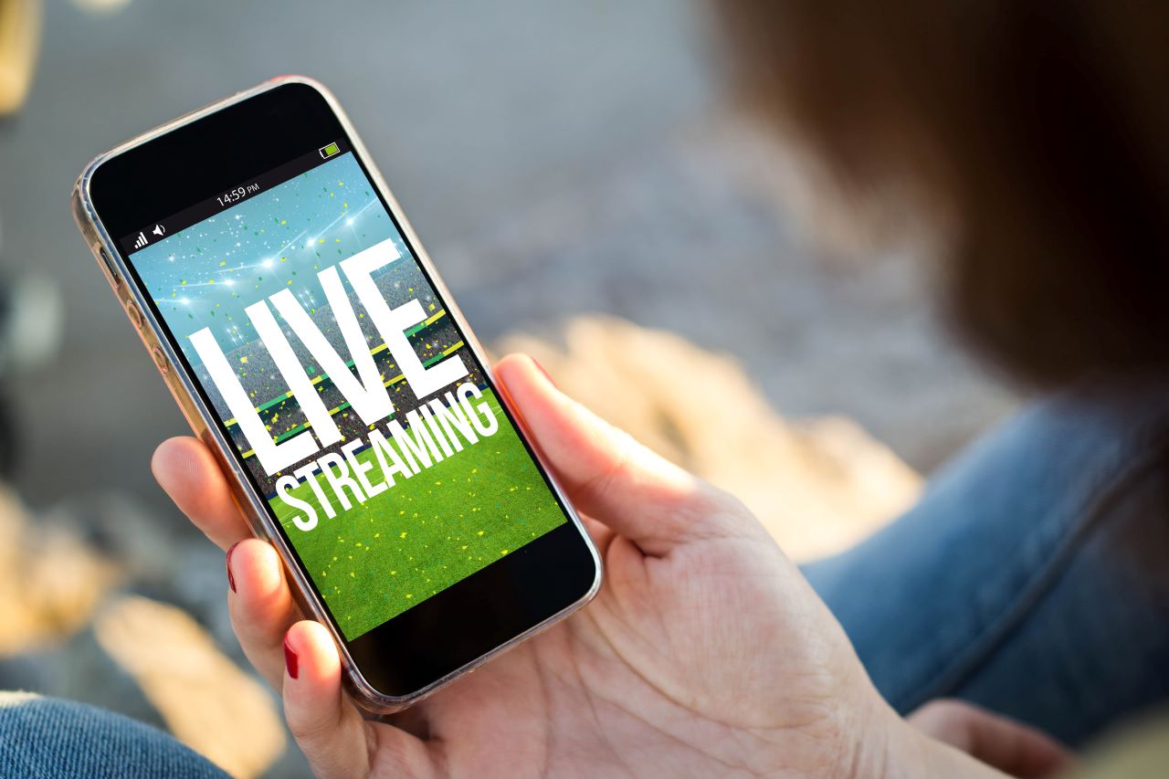 Person on Smartphone with text Live Streaming