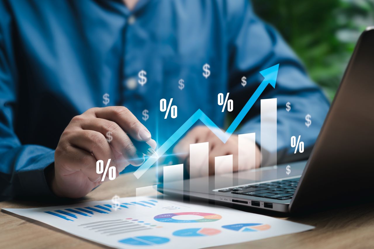 image of man in blue shirt with a chart and arrows showing increases