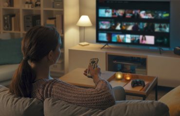 Woman at home watching TV