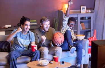 Men at home watching basketball
