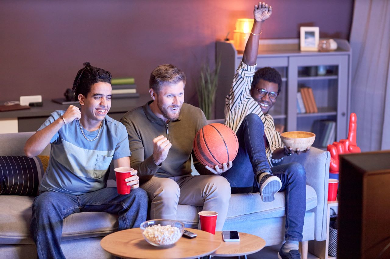 Men at home watching basketball