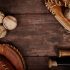Image of baseballs, gloves and bats on a wooden background