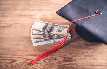 Graduation cap and dollars