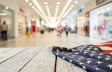 US flag on a wooded bench in shopping mall