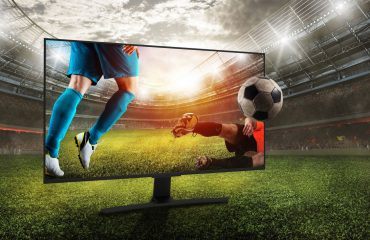 Soccer players on a tv in a soccer field