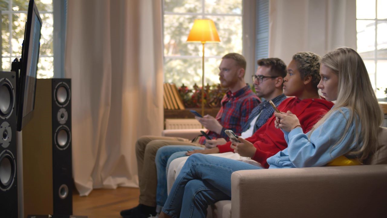 Young viewers watching tv and on their phones