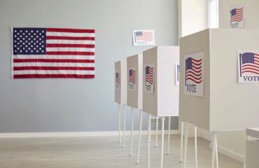 U.S voting booths and USA flags