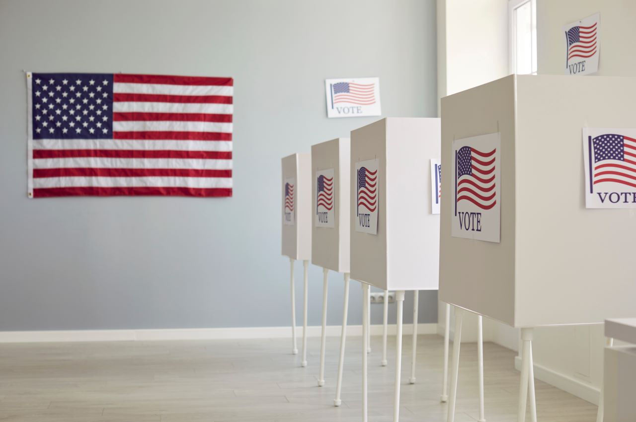 U.S voting booths and USA flags