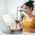 Young female at desk with computer and credit card in hand